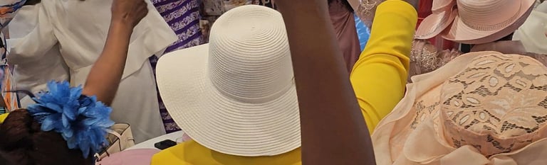 a group of women in hats and hands lifted up