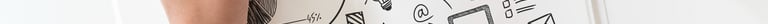 a person's hands holding a pen and drawing on a notebook