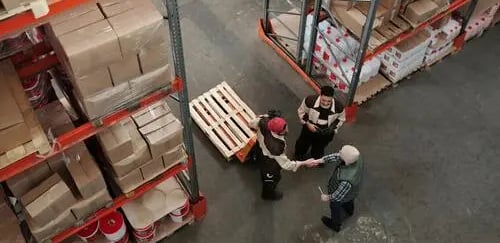 Warehouse workers managing inventory and logistics for supply chain operations