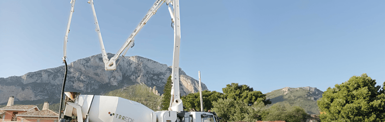 a cement mixer truck with a man standing next to it