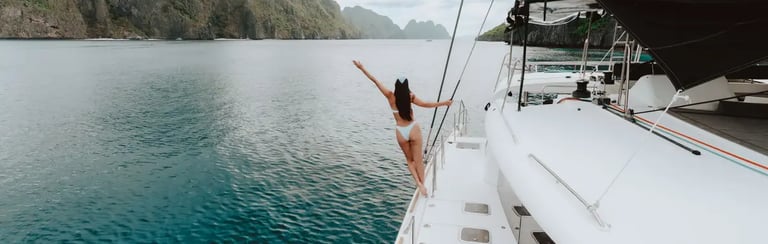 Private luxury yacht cruising through Bacuit Bay, El Nido.