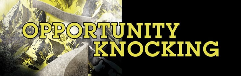 Raised, black/yellow fist stylized to appear like a mountain with the text "Opportunity Knocking"