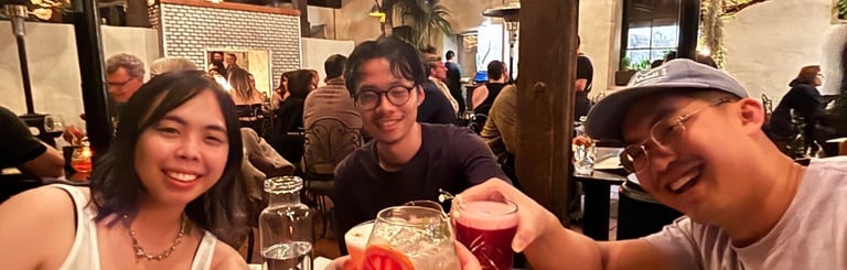 a group of people sitting at a table with drinks