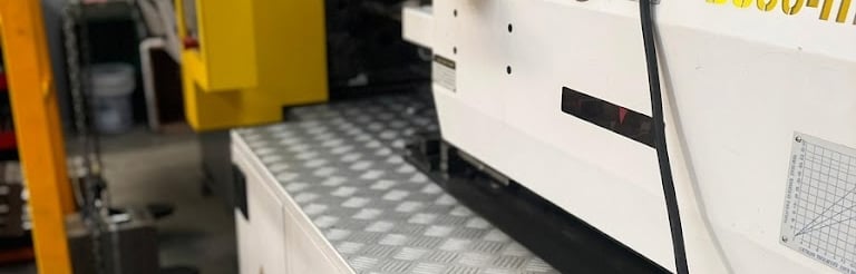 Industrial plastic injection molding machine model BS80-II in a manufacturing facility.