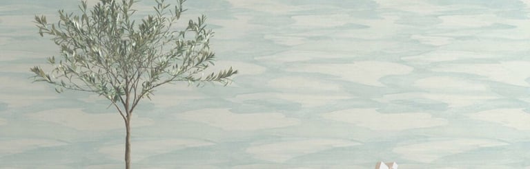 Light blue watercolor wave wallpaper behind a modern wood bench and potted olive tree.
