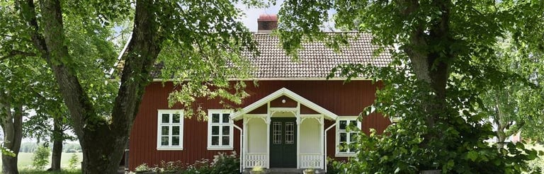 Une maison nichée dans la végétation peinte en peinte avec de la peinture naturelle suédoise à la farine
