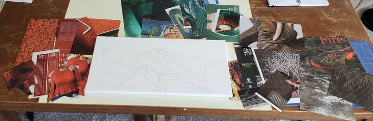 White canvas with an octopus pencil sketch surrounded by magazine collage clippings on a wooden desk.