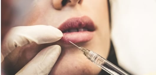 woman injecting botox into lips