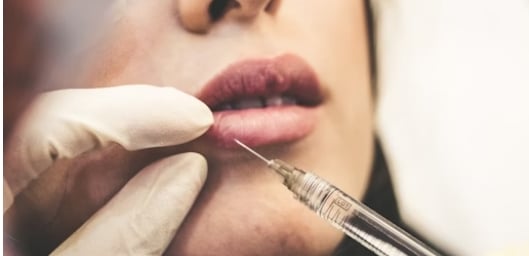 woman injecting botox into lips