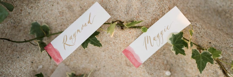 Luxury prewedding invitation detail on sand at Melasti Beach Bali