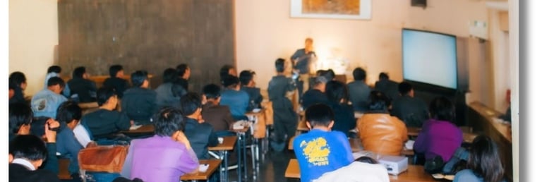 Repórteres, funcionários de revistas e equipes de televisão sentados olhando a demonstração do SFC