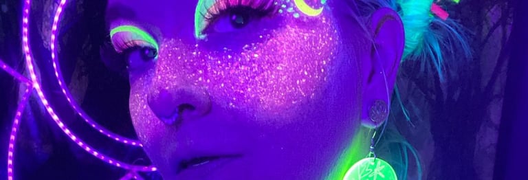 Illuma in blacklight with galaxy makeup which looks like a sky of a million stars across her face