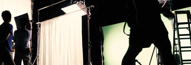 Film Crew sets up a green screen, working on a production funded after using Stelarator's marketplace tools