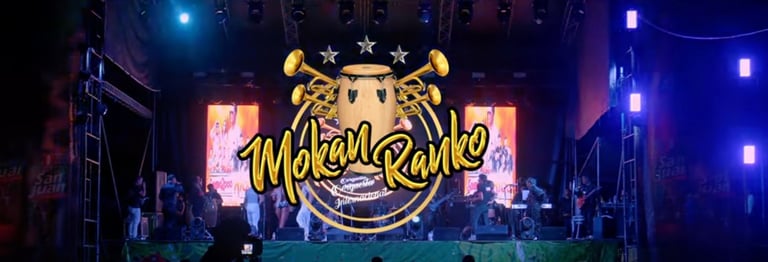 Mokanranko Internacional Orchestra performing on a lit stage performing their Cumbia Masha Hits