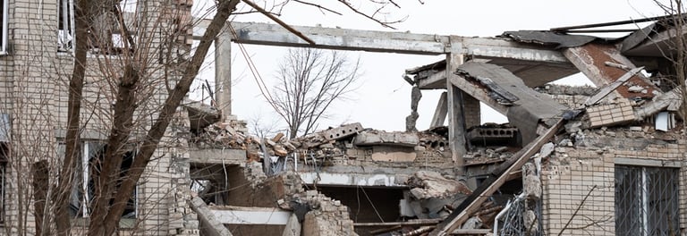 The image shows the remains of a severely damaged building