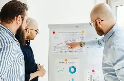Professionals reviewing go-to-market strategy and planning customer acquisition approach
