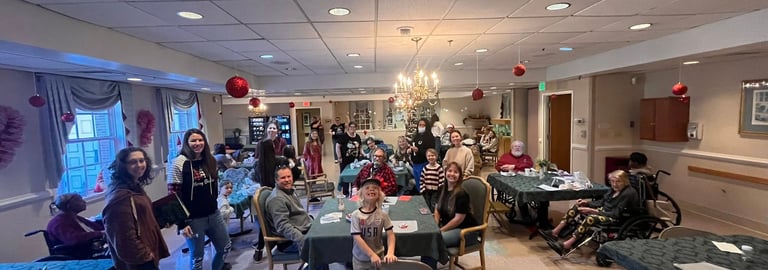 group of volunteers with Untether Life interacting with seniors