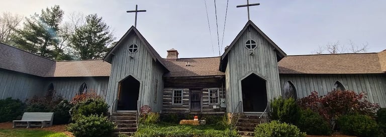 Mentone, AL - St. Joseph's church with an old log cabin in the middle