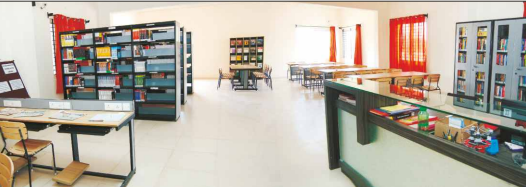 A spacious school library featuring organized bookshelves, study tables, and a reception desk.