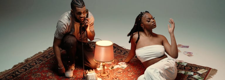 homme au téléphone assis avec une femme sur un tapis en studio fond blanc