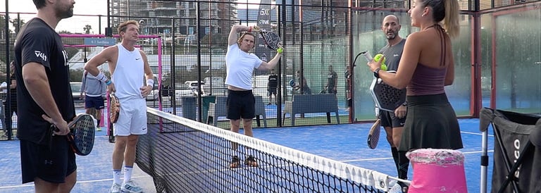 a group of people playing tennis on a court