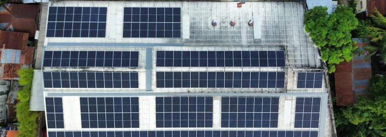 Aerial view of a commercial rooftop solar panel installation providing sustainable energy.