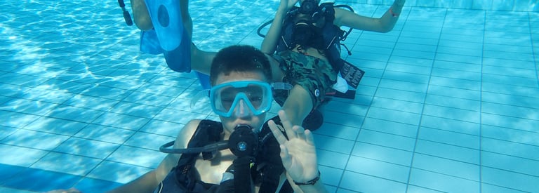 a group of people in scuba gear in a pool