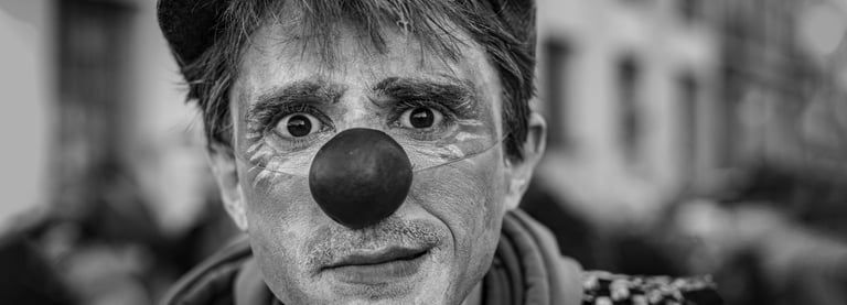a man with a clown nose and nose paint on his face