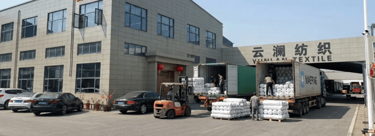 Textile factory loading fabric shipments at woven fabric manufacturer