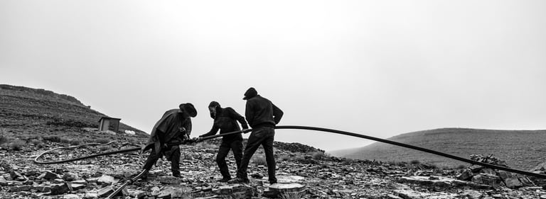 a group of men working on a mountain