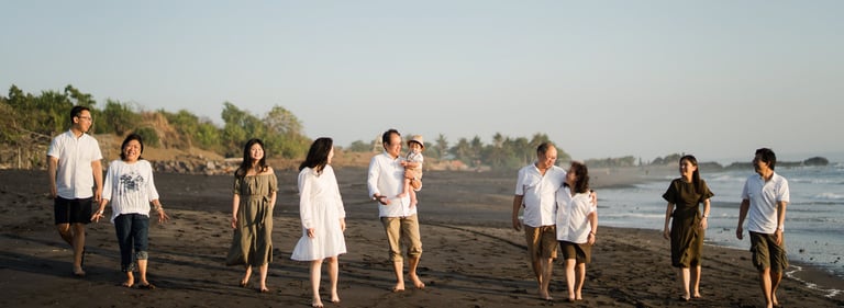 Family walking together along the shoreline of Nyanyi Beach Bali during a relaxed holiday family photography session