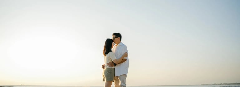 Family embracing on the beach during sunset at InterContinental Bali Resort