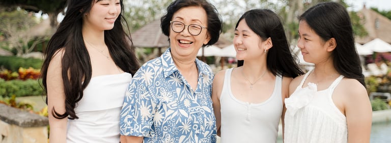 Grandma sharing a joyful moment with her daughters during a lifestyle family session at Ayana Resort Jimbaran Bali