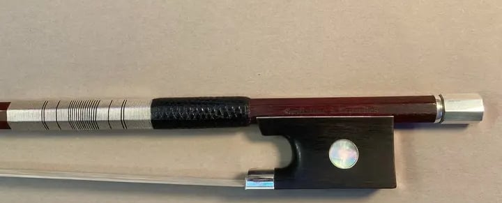 Violin bow with a sterling silver and black silk thread wrapping and a lizard skin grip