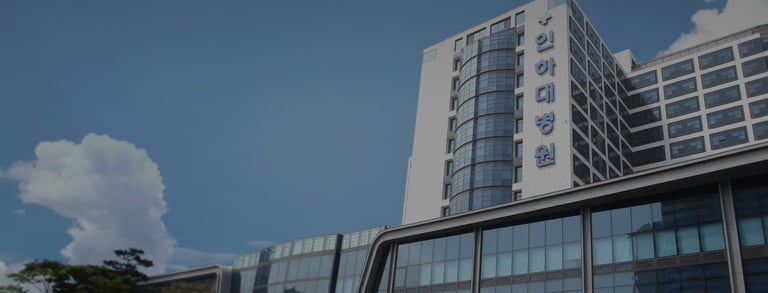 An image of exterior of Inha University Hospital on a nice, sunny day.