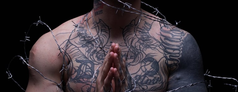 a man with tattoos on his chest and arms