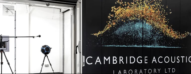 Large logo mural on black background flanked by professional audio equipment in white rooms