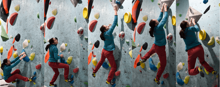 a woman doing dynamic movement on a climbing wall