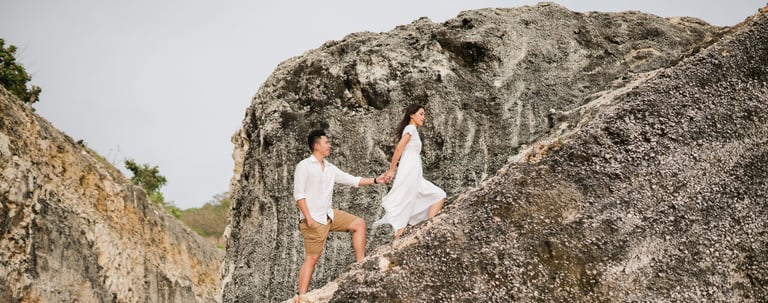 Couple walking on a cliff before proposal at Melasti Beach Bali