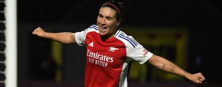 a woman soccer player is celebrating a goal