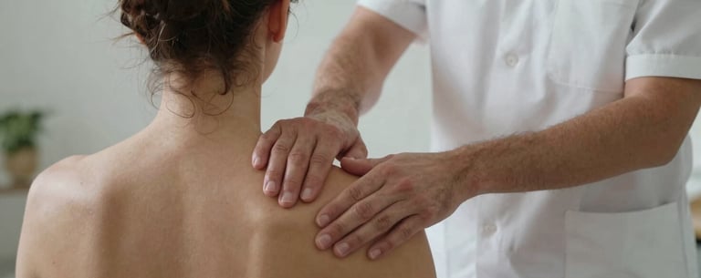 A Southern European therapist performing precise manual therapy on a patient's shoulder, focusing on the calm and professional environment of the clinic.