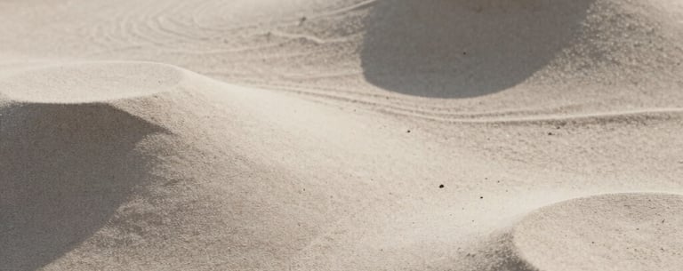 A minimalist composition of organic shapes, light-colored sand and shadows, evoking a sense of calm and balance, soft neutral tones.