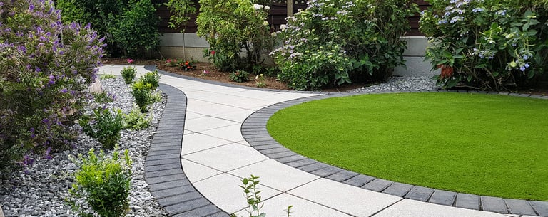 Patio with custom stone circle with aggregates and paving weaving through adventurous garden design