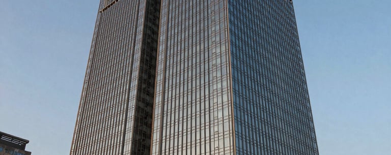 Exterior shot of a modern glass skyscraper in a South Asian / Indian city business park, dusk lighting, warm gold highlights and steel blue shadows, looking professional and established.