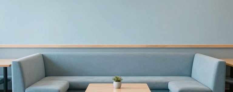 A minimalist reading area in a North American community center, with comfortable seating and pale blue decor promoting quiet reflection.