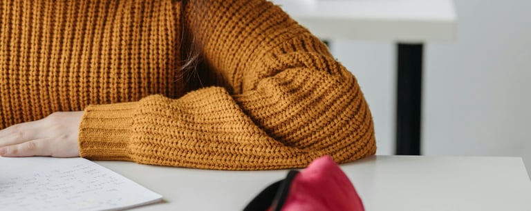 a woman in a yellow sweater is writing