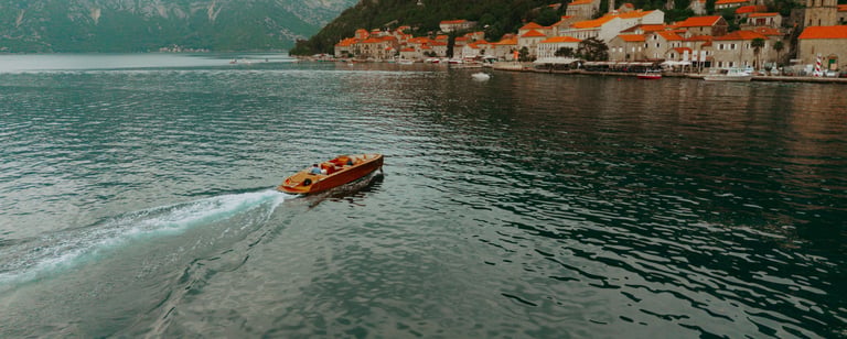 Couple walking along Perast waterfront, romantic Montenegro wedding photography