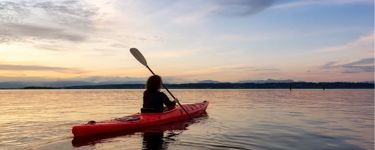 a person in a red kayak is in the water