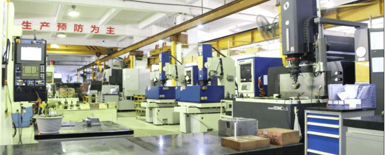 Precision CNC milling machines and EDM equipment in a modern industrial manufacturing workshop facility.