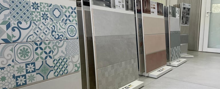 Showroom display featuring decorative pattern tiles and large ceramic wall tiles for home renovation.